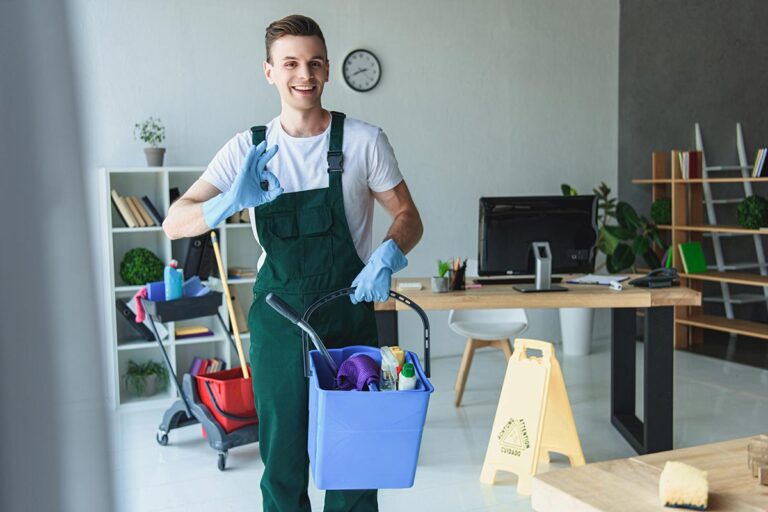 Worker holding a bucket of cleaning supplies