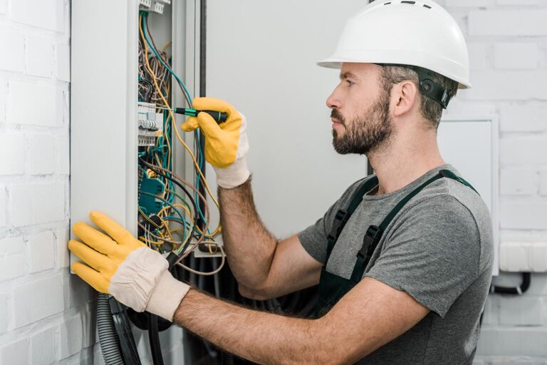 Electrician inspecting an electrical panel